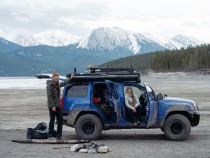 Claudio and Carlin in their four mud-stained four wheeler out in the backcountry