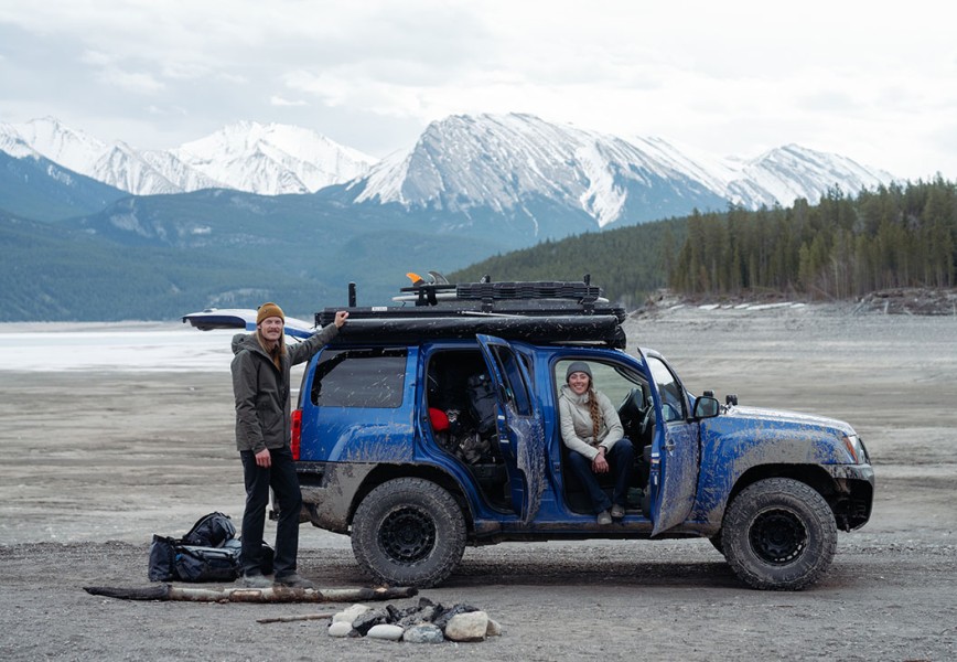 Claudio and Carlin in their four mud-stained four wheeler out in the backcountry